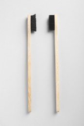 Photo of Old and new bamboo toothbrushes on white background, flat lay