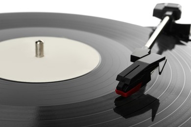 Photo of Closeup view of vinyl record on turntable against white background