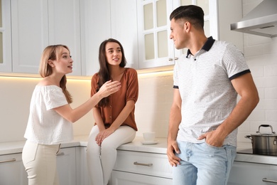 Photo of Group of people having conversation in kitchen