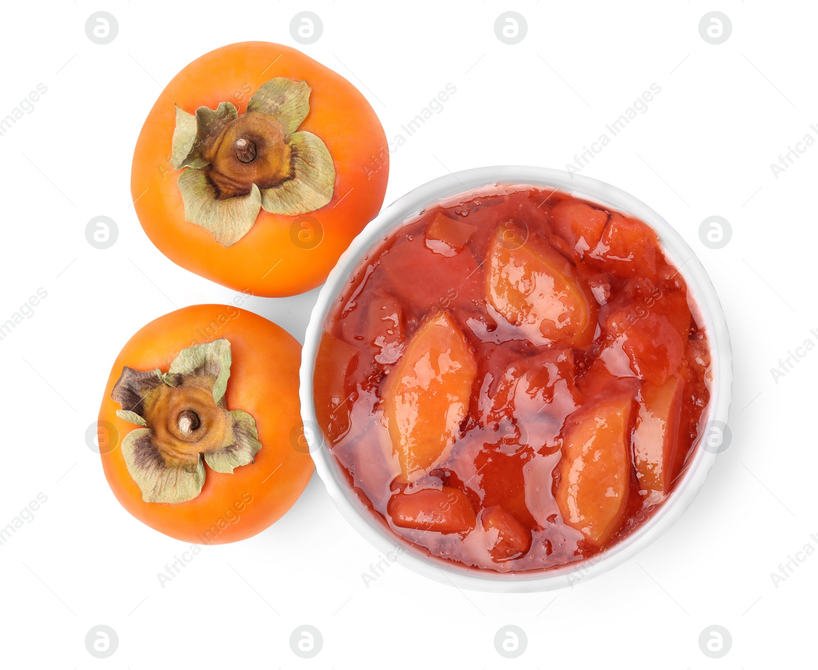 Photo of Bowl of tasty persimmon jam and fresh fruits on white background, top view