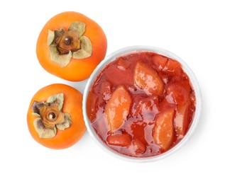 Photo of Bowl of tasty persimmon jam and fresh fruits on white background, top view