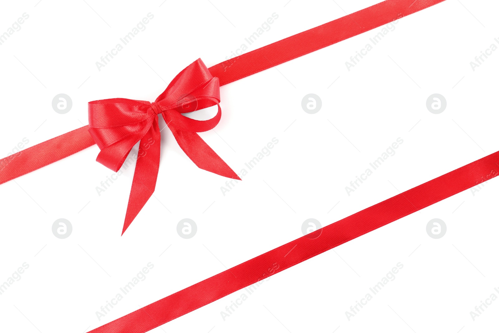 Photo of Red satin ribbons with bow on white background, top view