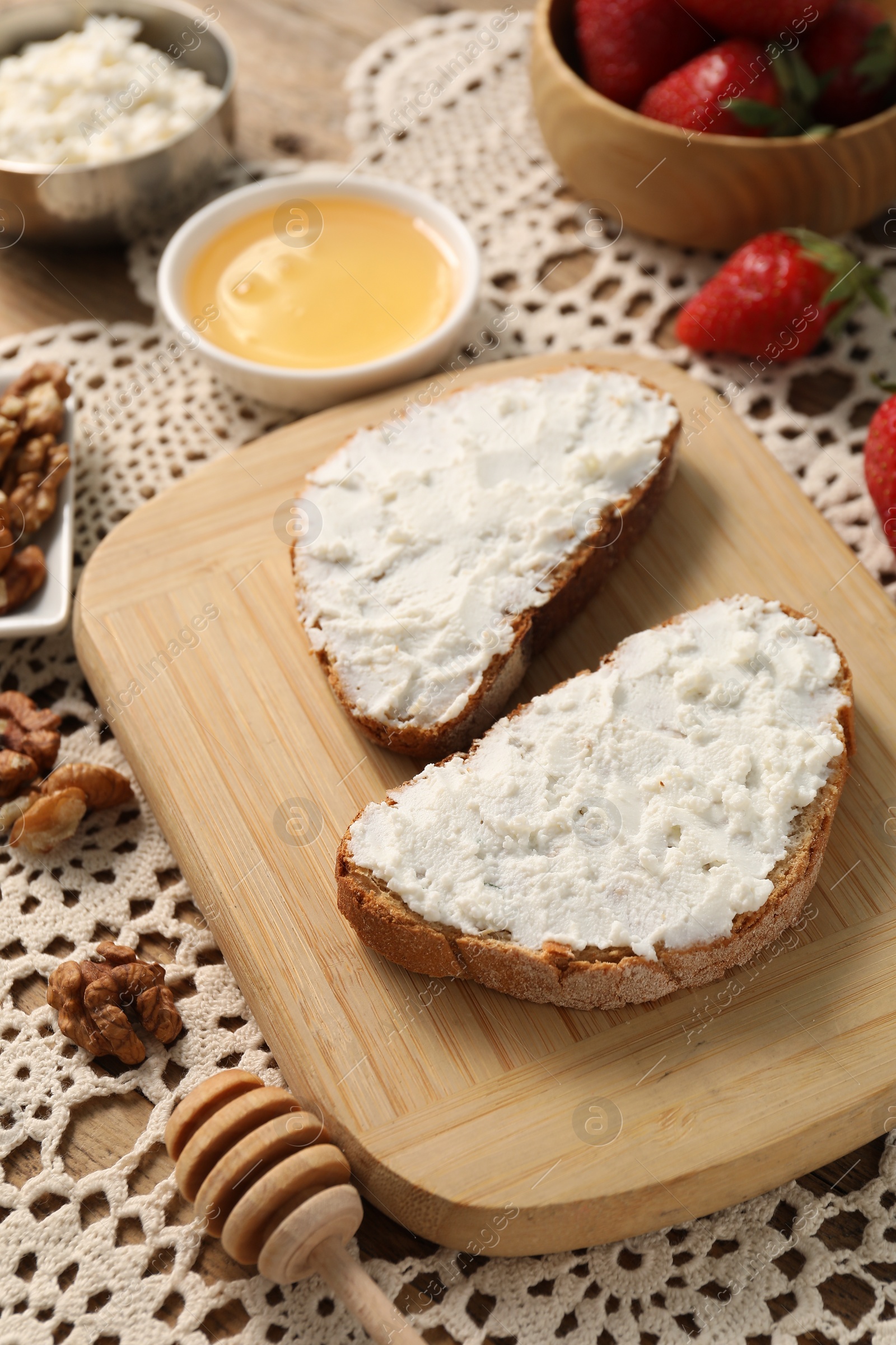 Photo of Delicious ricotta bruschettas and products on table