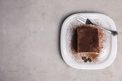 Photo of Top view of tiramisu cake with coffee beans on table, space for text