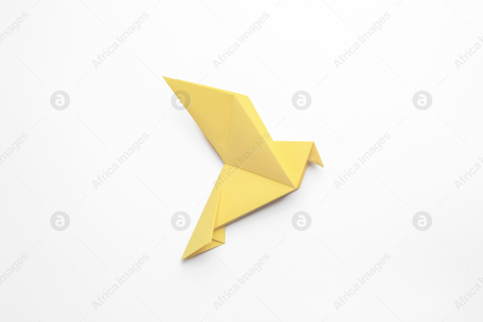 Photo of Beautiful yellow origami bird on white background, top view