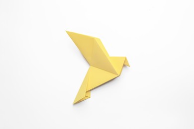 Photo of Beautiful yellow origami bird on white background, top view
