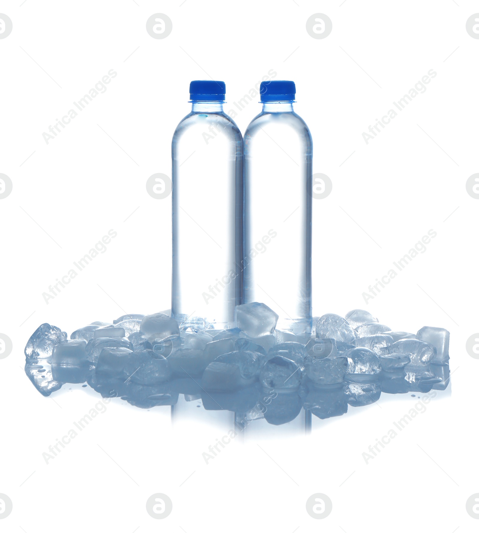 Photo of Bottles of water and ice cubes on white background