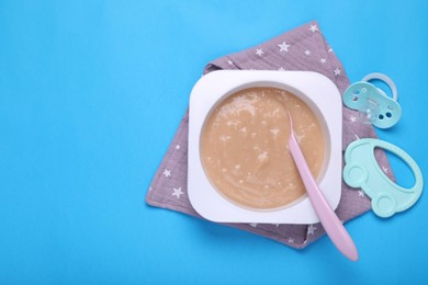 Photo of Flat lay composition with healthy baby food on light blue background. Space for text