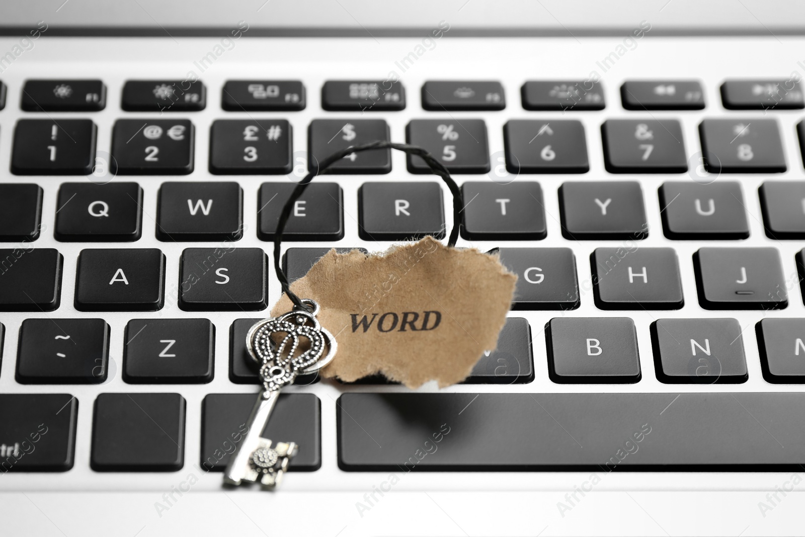 Photo of Key with tag WORD on laptop keyboard, closeup. Keyword concept