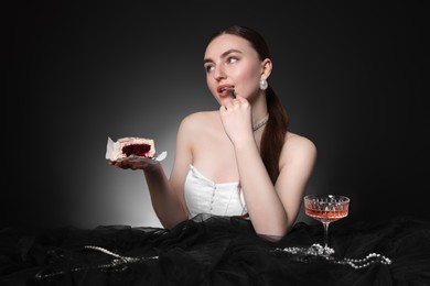 Photo of Fashionable photo of attractive woman with her Birthday cake and glass of wine on black background