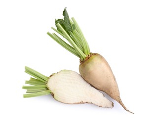 Whole and cut sugar beets on white background