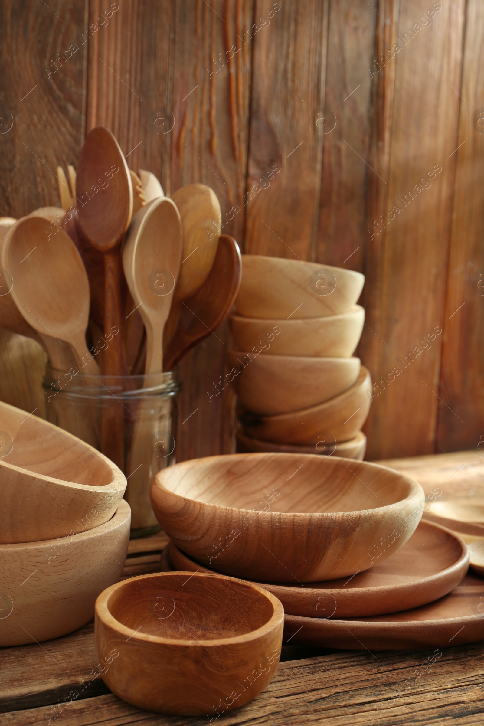 Photo of Many different wooden dishware and utensils on table