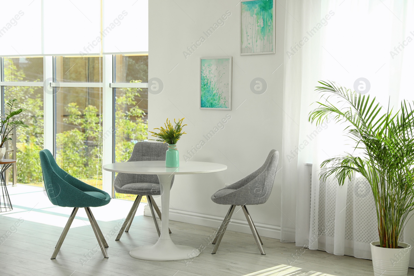 Photo of Modern living room interior with round table and stylish chairs