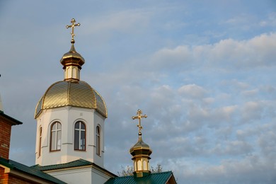 Beautiful view of village church against blue sky, space for text