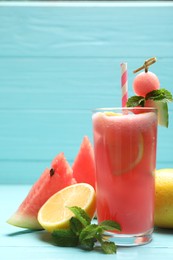 Photo of Delicious fresh watermelon drink on light blue wooden table
