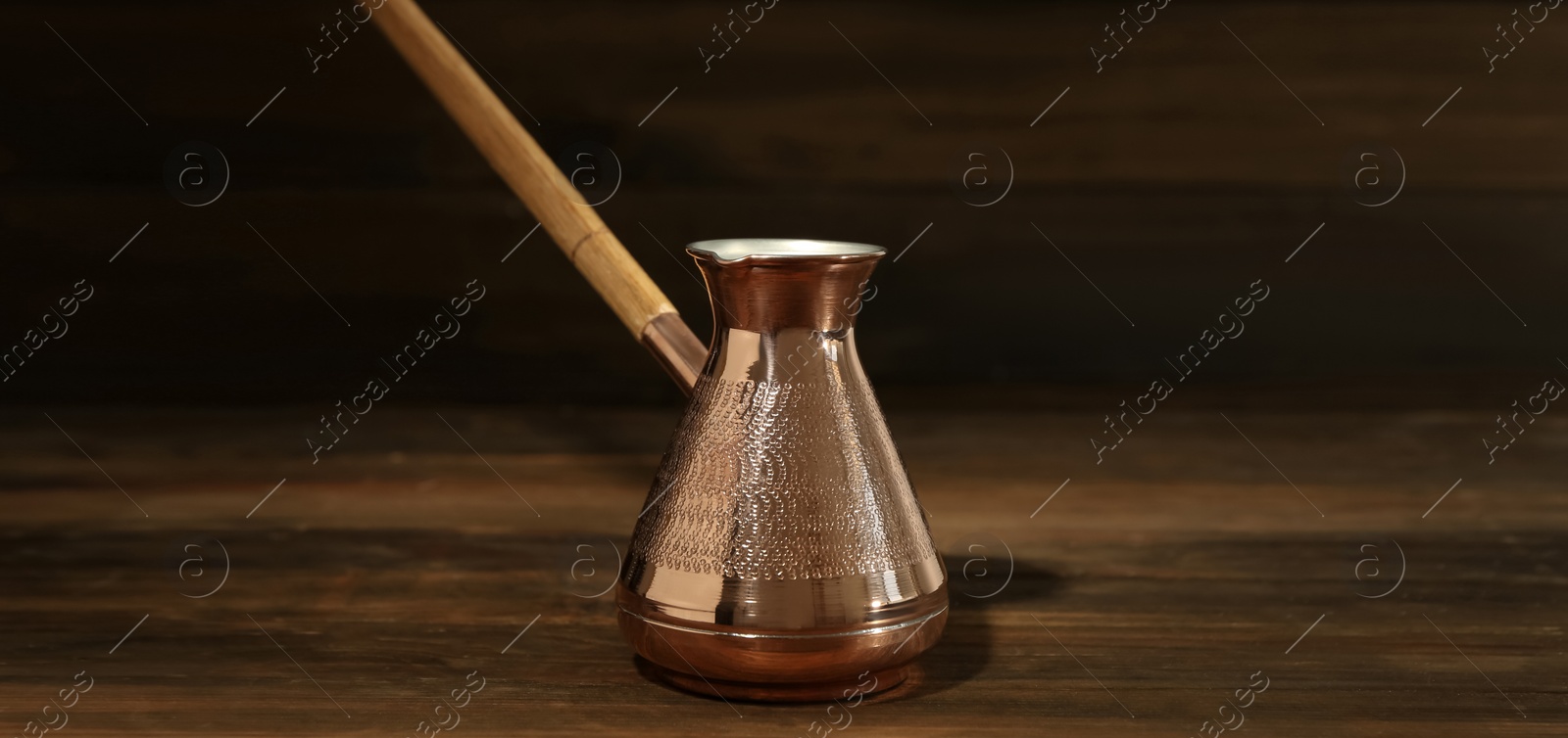 Image of Turkish coffee. Cezve on wooden table. Banner design