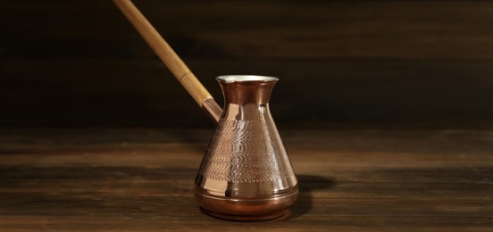 Image of Turkish coffee. Cezve on wooden table. Banner design