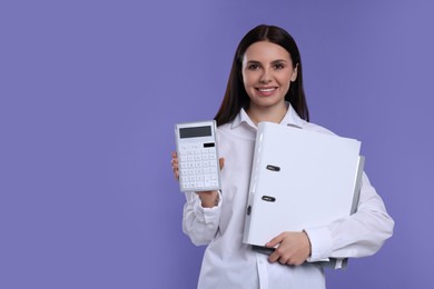Smiling accountant with calculator and folders on purple background