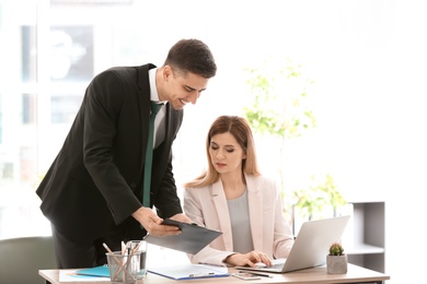 Young consultant working with client in office