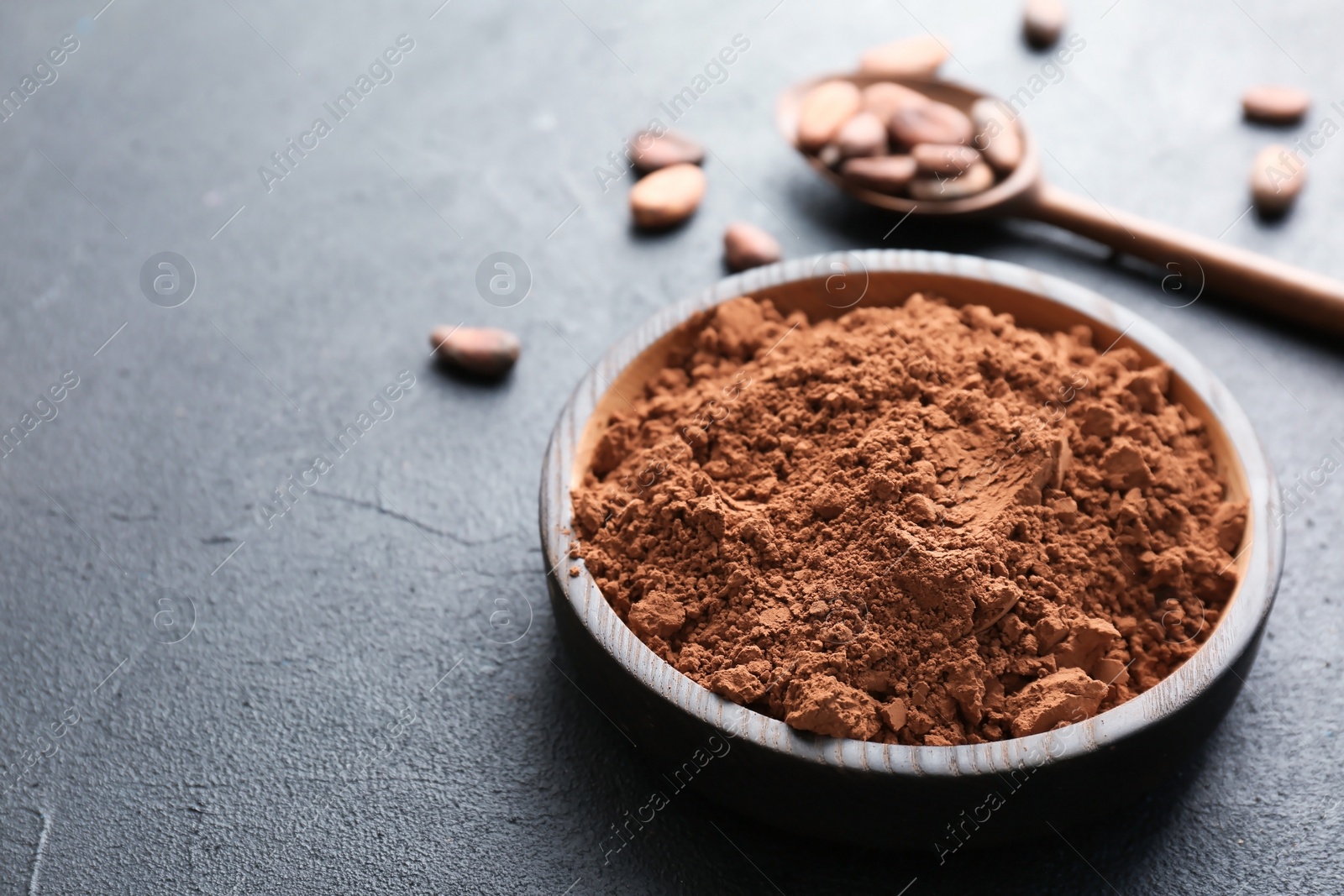 Photo of Plate with cocoa powder on grey background