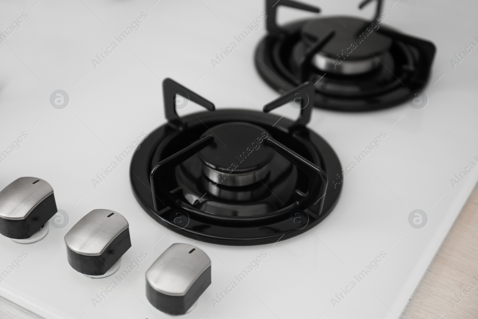 Photo of Modern built-in gas cooktop, closeup. Kitchen appliance