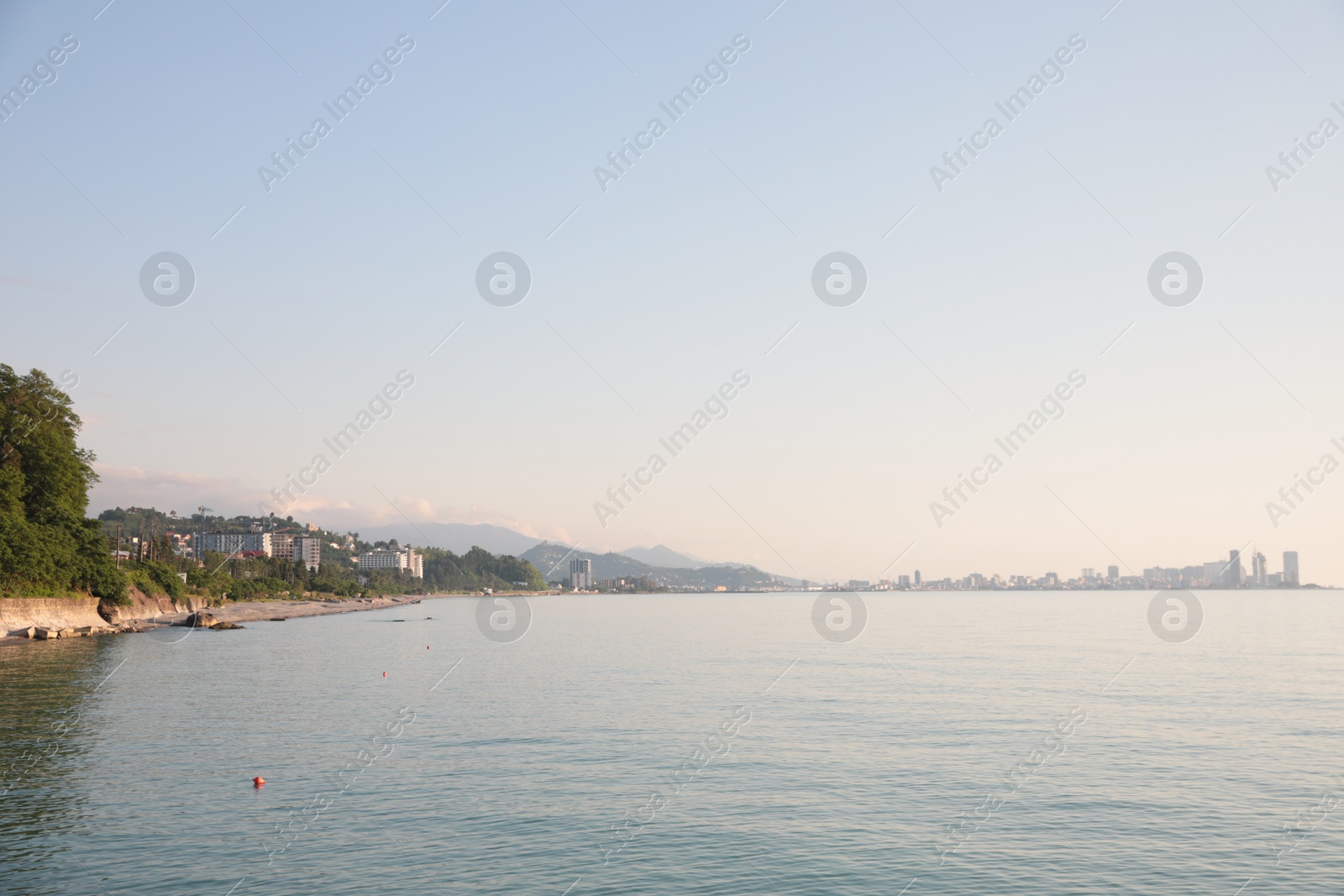 Photo of Picturesque view of sea and city under sky outdoors