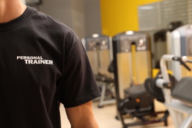 Personal trainer in modern gym, closeup view