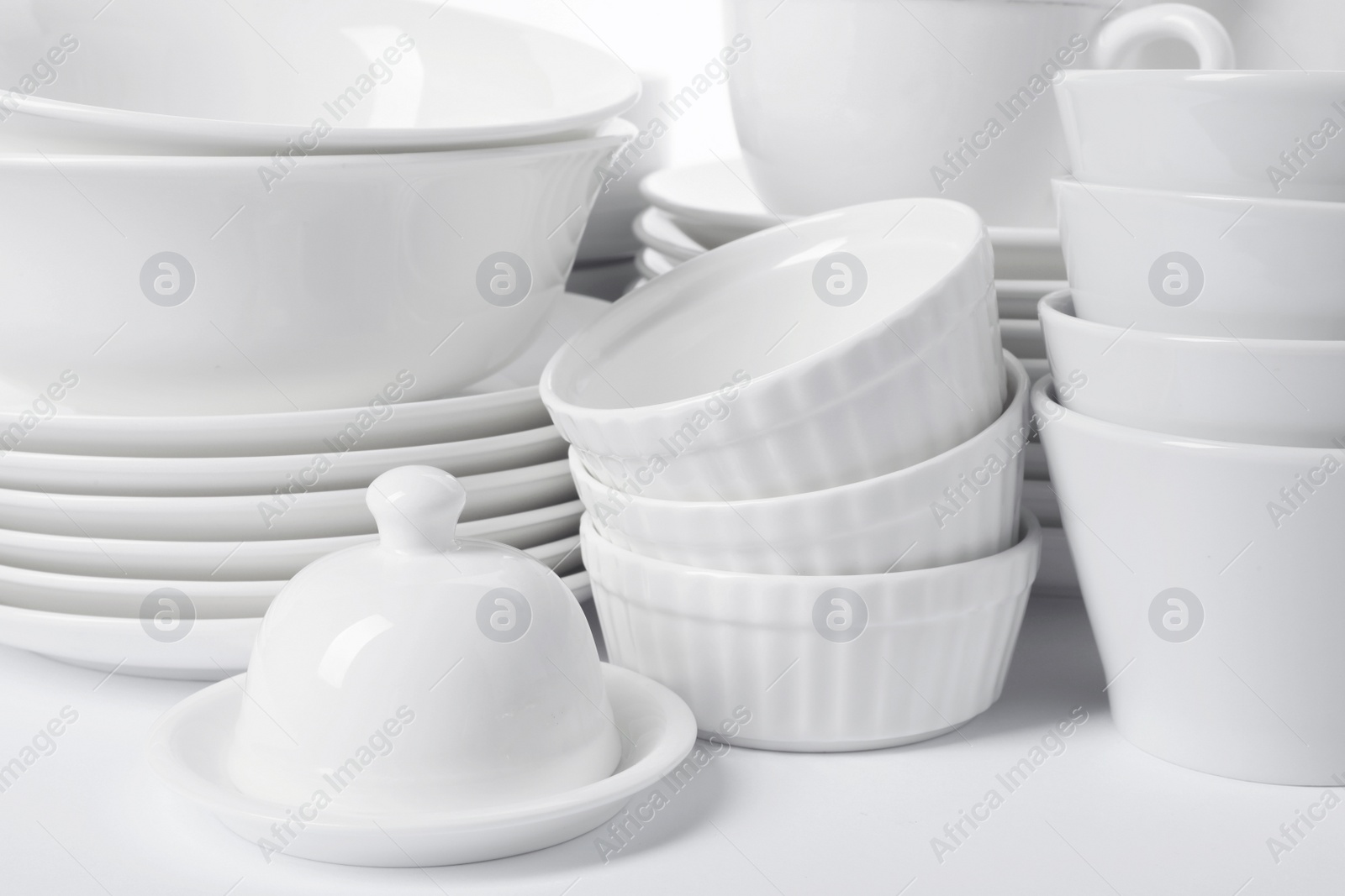 Photo of Set of clean tableware on white background, closeup. Washing dishes