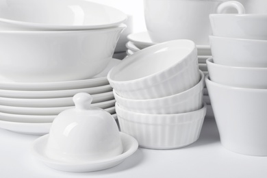 Set of clean tableware on white background, closeup. Washing dishes