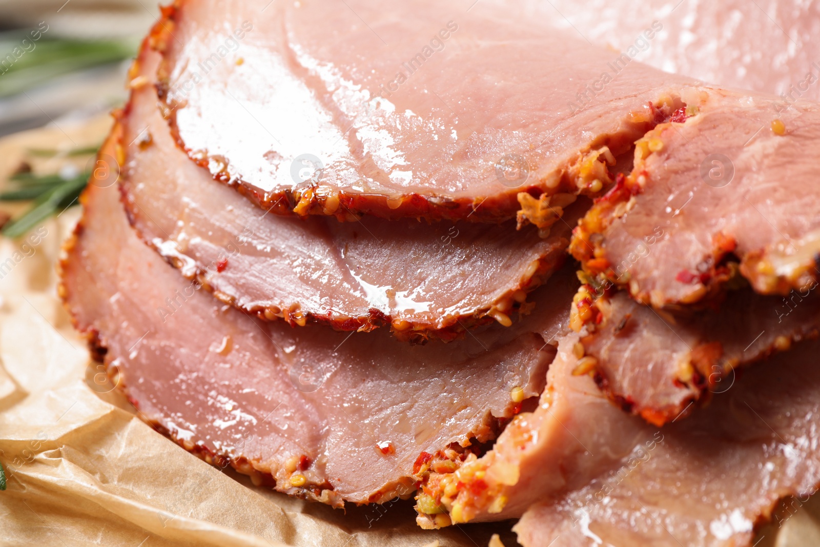 Photo of Slices of delicious cooked ham on parchment, closeup