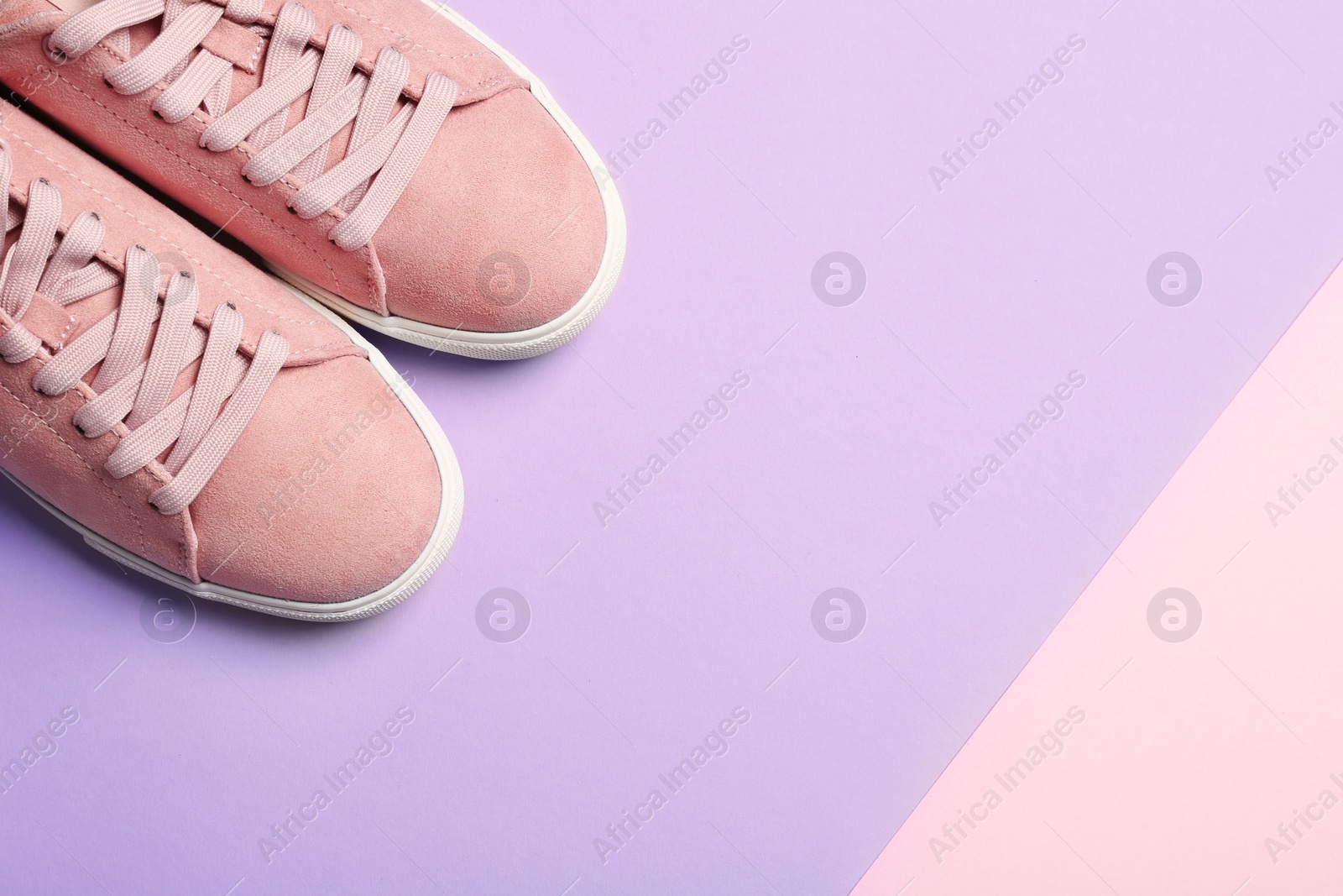 Photo of Bright stylish shoes on color background, top view. Space for text