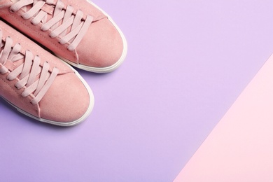 Photo of Bright stylish shoes on color background, top view. Space for text