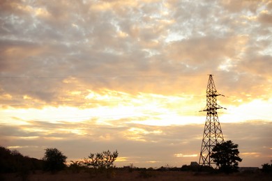 Picturesque view of landscape with transmission tower and beautiful cloudy sky