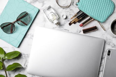 Photo of Flat lay composition with laptop and blogger's stuff on marble background