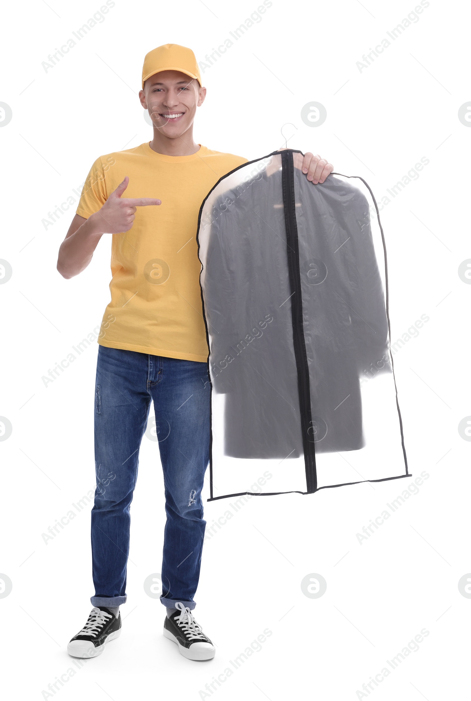 Photo of Dry-cleaning delivery. Happy courier holding garment cover with clothes on white background