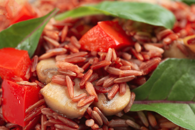 Photo of Tasty brown rice with bell pepper and mushroom, closeup