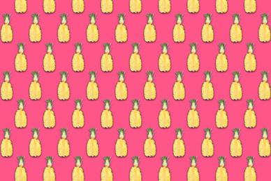 Pattern of pineapple halves on bright pink background