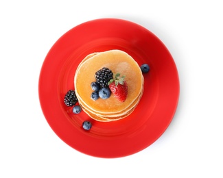 Plate with stack of tasty pancakes and fresh berries on white background, top view