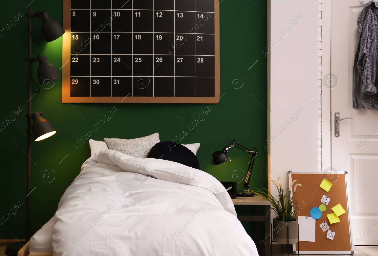 Photo of Modern teenager room interior with comfortable bed against green wall