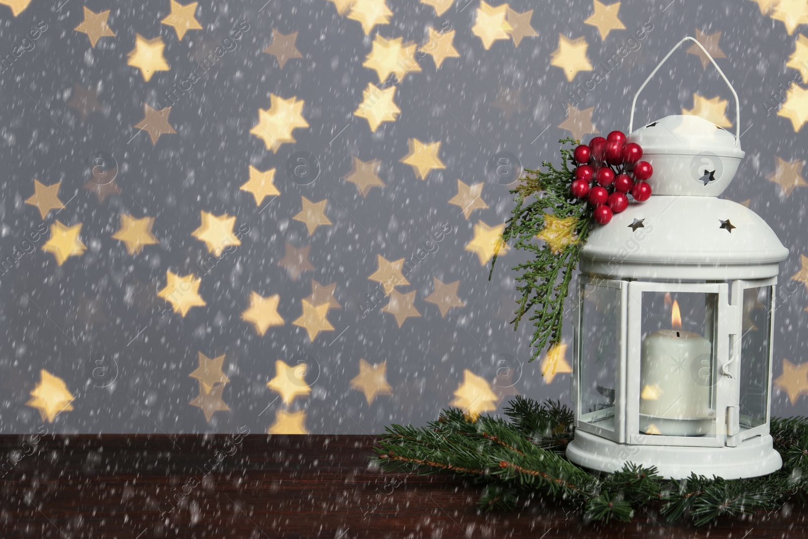 Image of Composition with Christmas lantern on wooden table, space for text. Bokeh effect