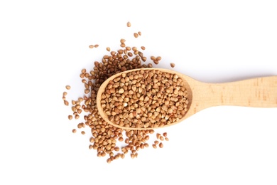 Spoon with uncooked buckwheat on white background, top view