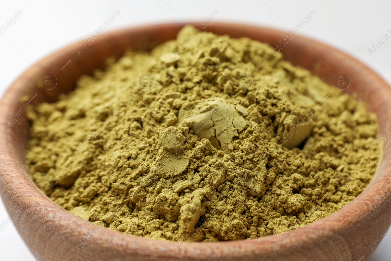 Photo of Bowl of henna powder on white marble table, closeup