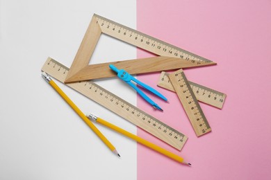 Flat lay composition with different rulers and compass on color background