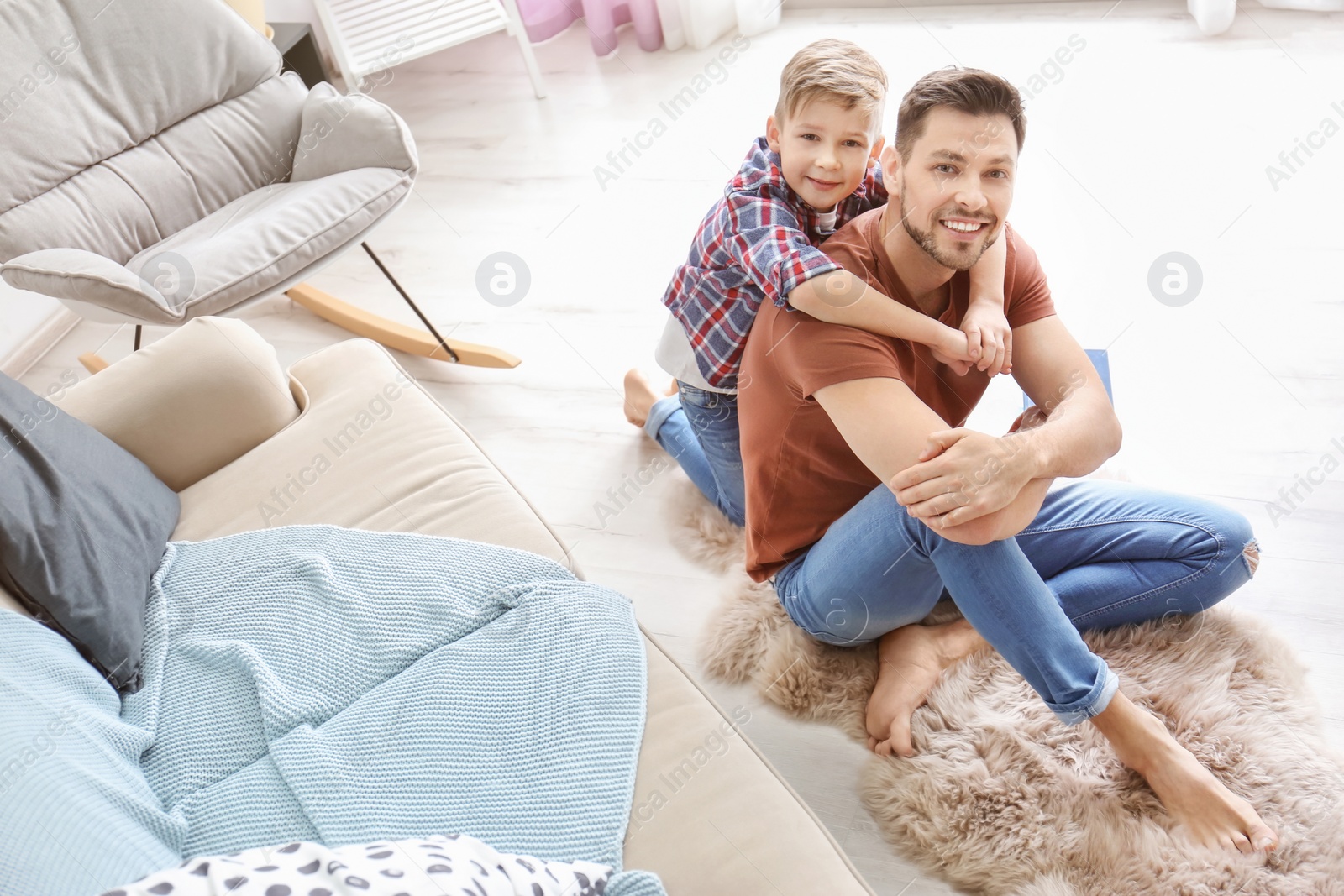 Photo of Little boy and his dad spending time together at home