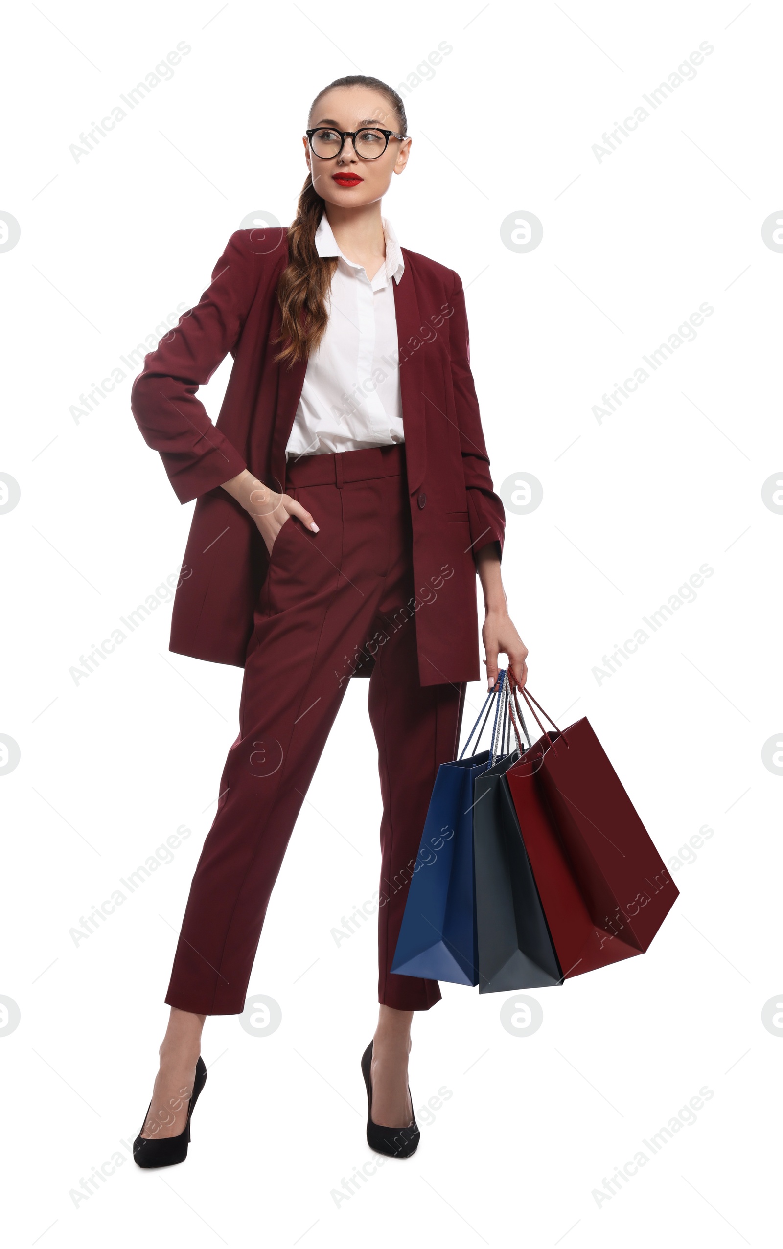 Photo of Stylish young businesswoman with shopping bags on white background