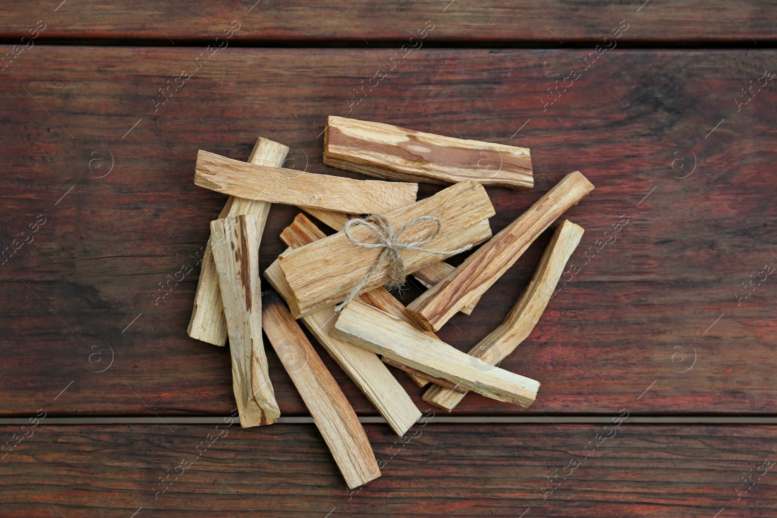 Photo of Many palo santo sticks on wooden table, flat lay