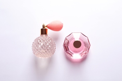 Composition with bottles of perfume on white background, top view