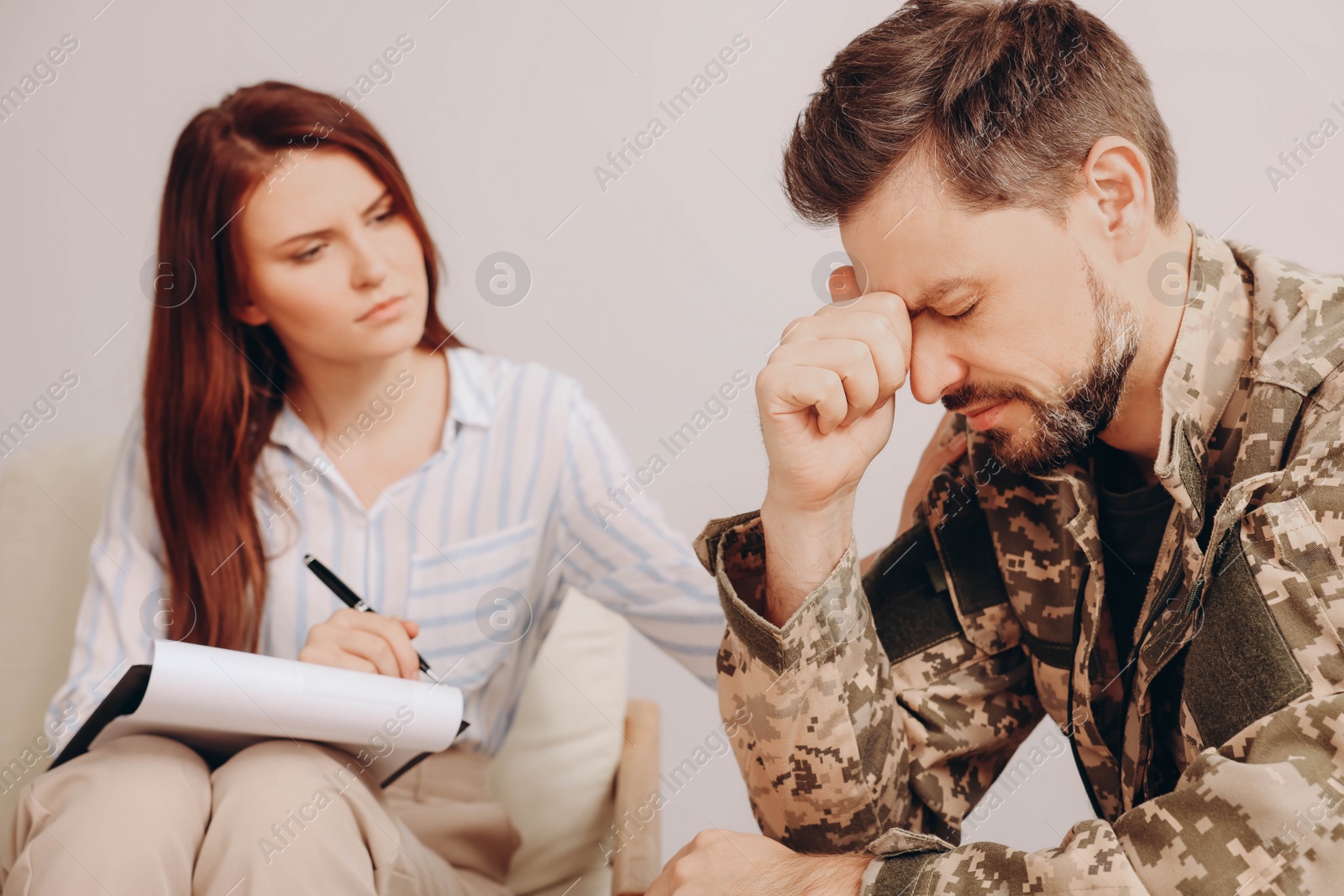 Photo of Psychologist working with military officer in office