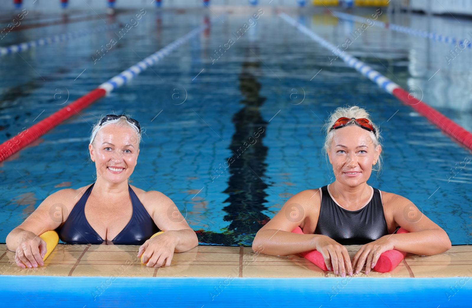 Photo of Sportive senior women in indoor swimming pool