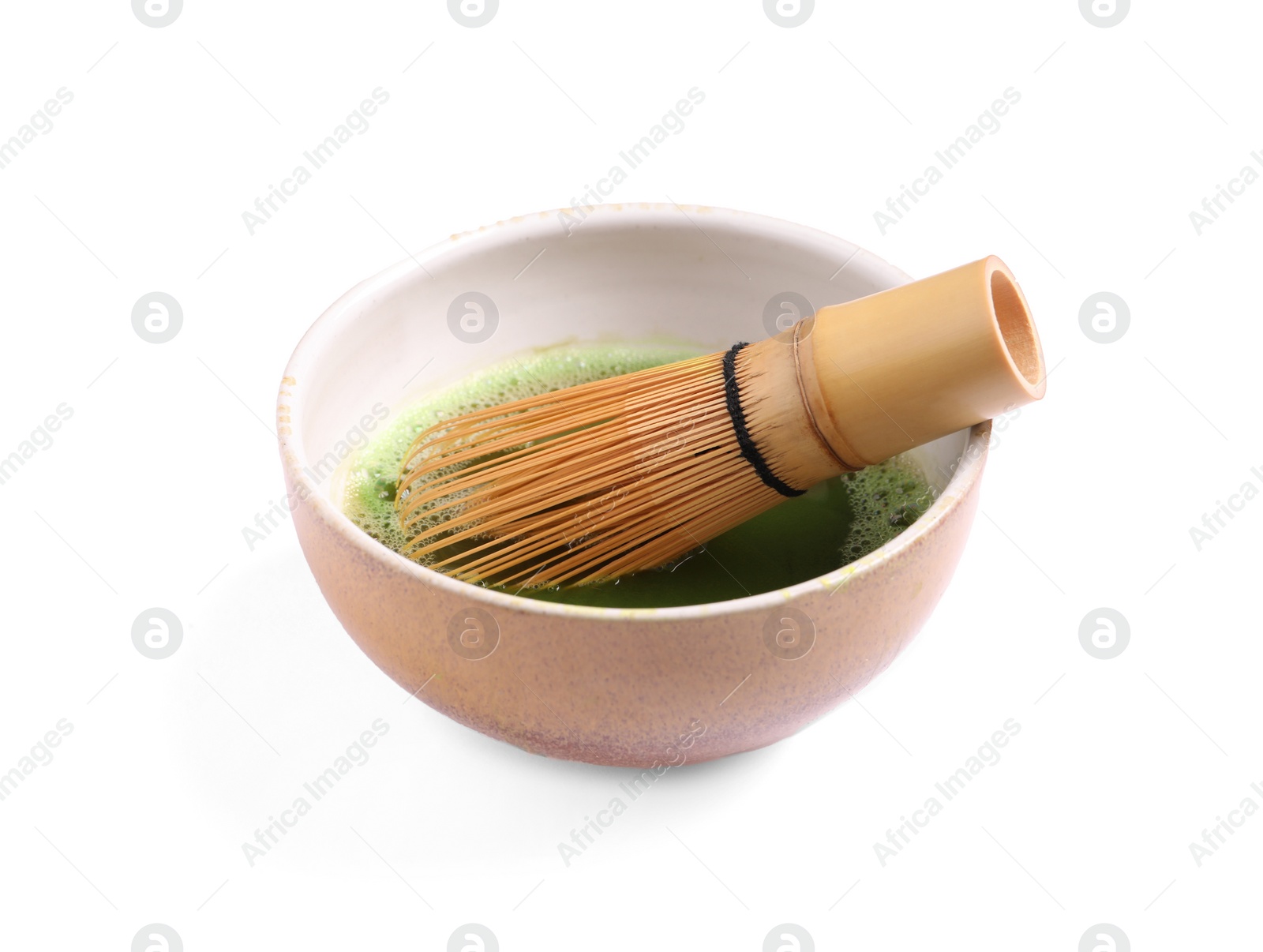 Photo of Bowl of fresh matcha tea with bamboo whisk isolated on white